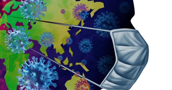 A world map covered by coronavirus and a person wearing a mask