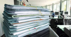 Documentation for PCI Compliance sitting on an office desk.