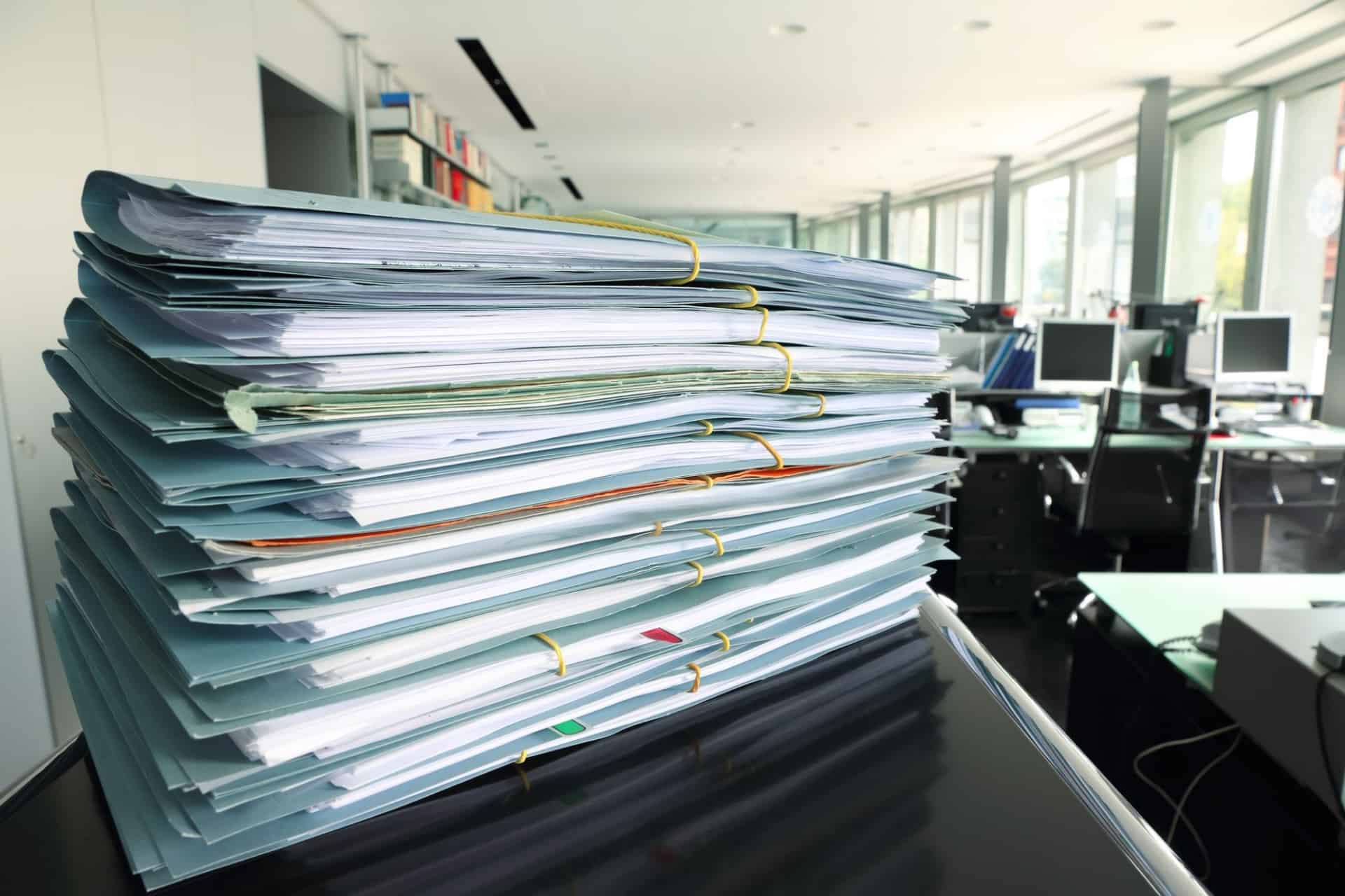 Documentation for PCI Compliance sitting on an office desk.