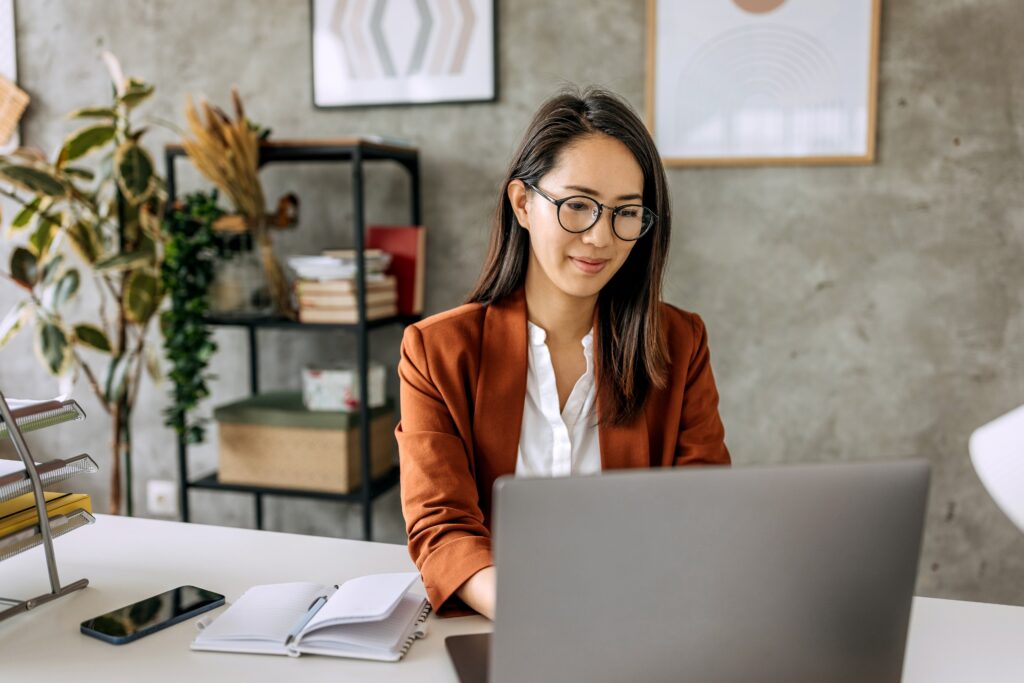 A finance professional uses a laptop to securely access financial management information.