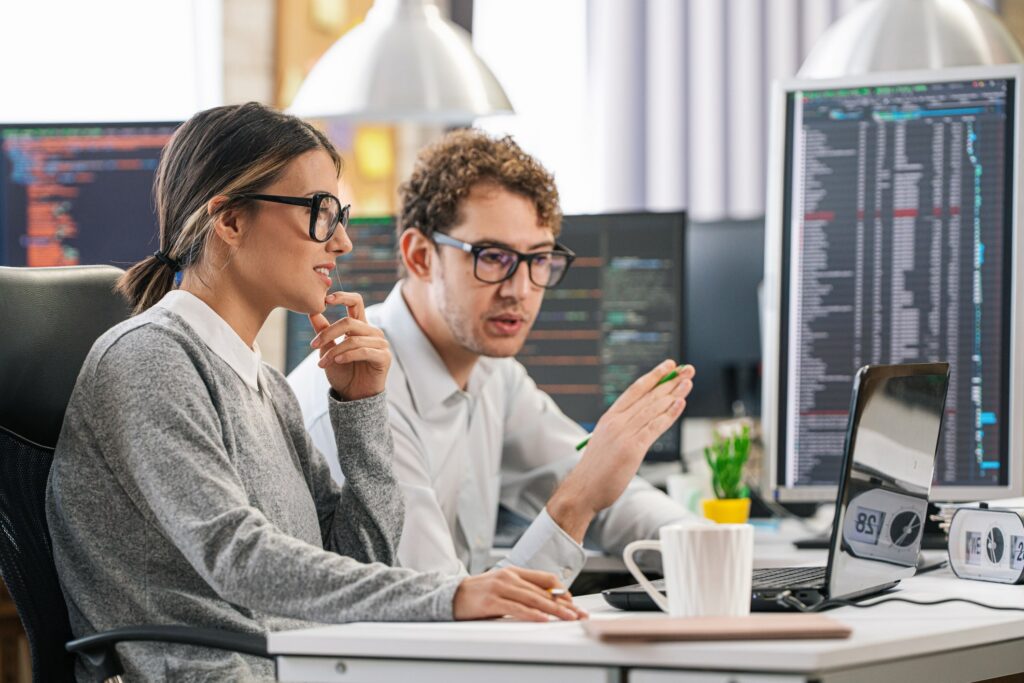 A cybersecurity expert at IS Partners helps their client conduct a security risk analysis using their security risk assessment tool.