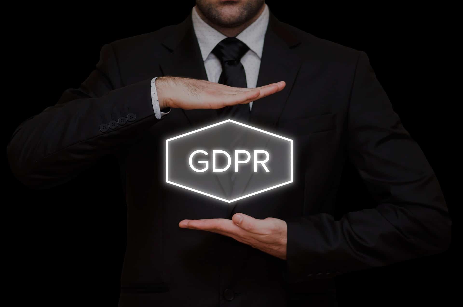 business man holds a sign with GDPR written on it